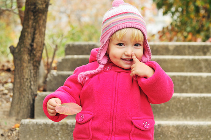 toddler girl pointing her nose